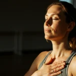 Kvinne praktiserer pusteteknikk i rolig yogastudio for nervesystem-regulering
